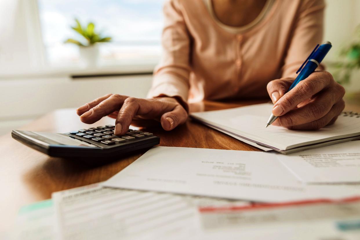 hands with calculator and financial papers