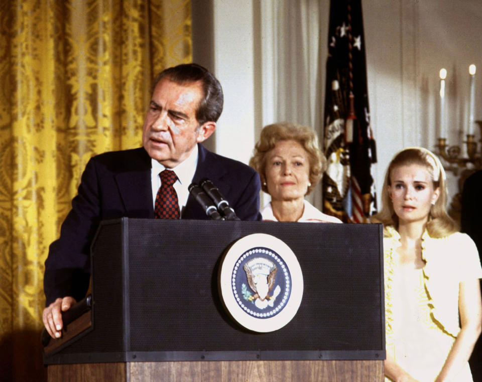 <p>President Nixon, with first lady Pat Nixon and daughter Tricia Nixon, says goodbye to family and staff in the White House East Room on August 9, 1974. Nixon resigned his office, or “resigned in disgrace” as many of the news accounts would say, as it became clear the House of Representatives would impeach him for Watergate misdeeds and the Senate would follow by convicting him. (Photo: Stringer/Reuters) </p>