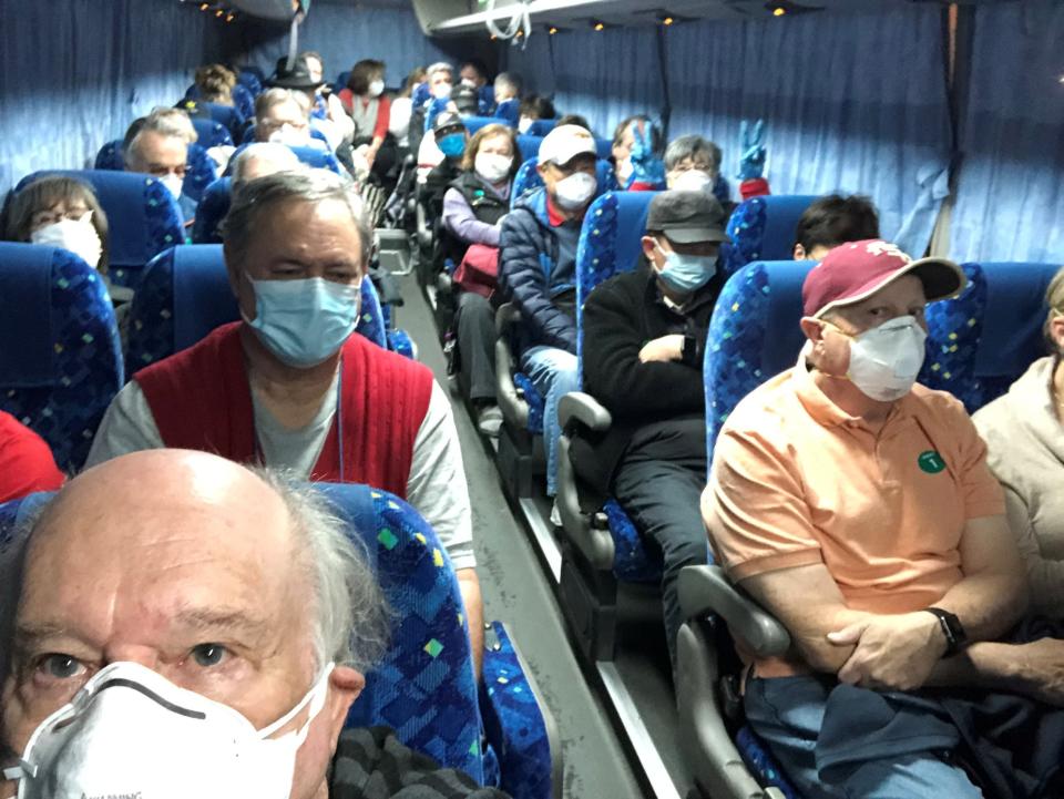 US passengers on board the Diamond Princess cruise ship, who have chosen to leave, are transported by shuttle bus in Yokohama to Haneda airport (via REUTERS)