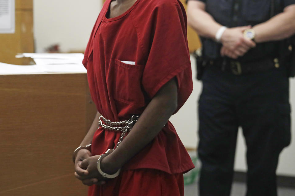 Dawit Kelete wears handcuffs chained to his waist as he walks into a court appearance Monday, July 6, 2020, in Seattle. Kelete is accused of driving a car on to a closed Seattle freeway and hitting two protesters, killing one, over the weekend. Seattle has been the site of prolonged unrest over the death of George Floyd, a Black man who was in police custody in Minneapolis. (AP Photo/Elaine Thompson)