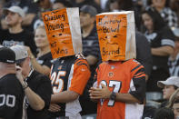 Cincinnati Bengals fans wears paper bags on their heads during the second half of an NFL football game against the Oakland Raiders in Oakland, Calif., Sunday, Nov. 17, 2019. (AP Photo/Ben Margot)