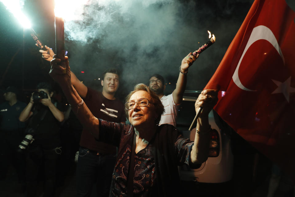 Supporters of Ekrem Imamoglu, the candidate of the secular opposition Republican People's Party, CHP, light up a flare as they celebrate in central Istanbul, Sunday, June 23, 2019. In a blow to Turkish President Recep Tayyip Erdogan, Imamoglu declared victory in the Istanbul mayor's race for a second time Sunday after Binali Yildirim, the government-backed candidate conceded defeat in a high-stakes repeat election. (AP Photo/Lefteris Pitarakis)