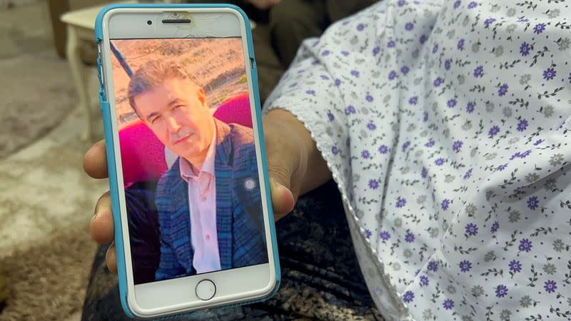 Bahar Tawfik shows a photo of her deceased husband Ibrahim Mohsen Mohamed, in her home where Mohamed was shot in the chest in August 2021, while irrigating his farm in Dashish village, near the Iraqi-Turkish border, in Dohuk