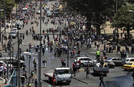 People clean debris from the streets in the aftermath of the last days' protests in Quito