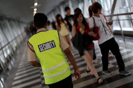 A security guard patrolling at a pedestrian walkway bridge in Kuala Lumpur in August 8. The fear of crime is soaring in Malaysia as personal tales of abduction, assault and robbery go viral online, upping pressure on authorities to respond and triggering scrutiny of official claims that offences are down