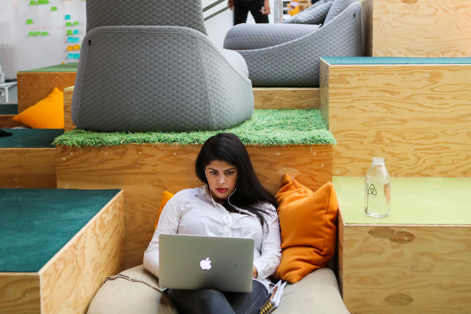 A woman works at her Apple computer at the Airbnb office headquarters in the SOMA district of San Francisco, California, U.S., August 2, 2016.   REUTERS/Gabrielle Lurie