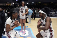 South Carolina guard MiLaysia Fulwiley, left, and guard Raven Johnson celebrate after a win over Notre Dame in an NCAA college basketball game Monday, Nov. 6, 2023, in Paris. (AP Photo/Thibault Camus)
