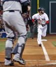 Boston Red Sox's Dustin Pedroia runs home to score on a single by A.J. Pierzynski in the first inning of a baseball game against the New York Yankees at Fenway Park in Boston, Wednesday, April 23, 2014. (AP Photo/Elise Amendola)