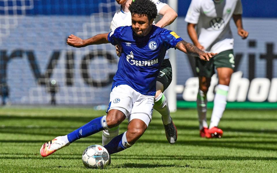 Schalke's Weston McKennie, in front, and Wolfsburg's Maximilian Arnold challenge for the ball during the German Bundesliga soccer match between FC Schalke 04 and VfL Wolfsburg - AP