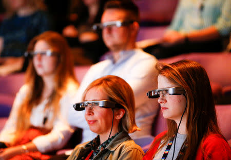 People watch a live performance of Exit the King at the National Theatre while wearing Smart Caption Glasses, designed by Epson, in London, Britain, October 3, 2018. REUTERS/Henry Nicholls