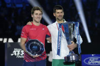 Serbia's Novak Djokovic and Norway's Casper Ruud, right, poses with their trophies after the singles final tennis match of the ATP World Tour Finals at the Pala Alpitour, in Turin, Italy, Sunday, Nov. 20, 2022. Djokovic defeated Ruud 7-5, 6-3. (AP Photo/Antonio Calanni)