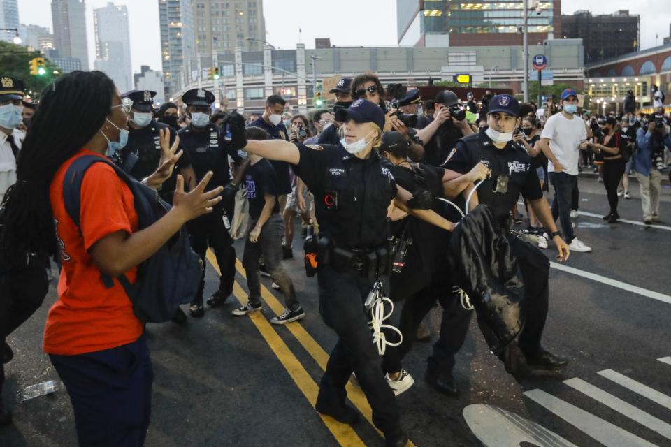 A Police officer warns a protester during an arrest at a rally Friday, May 29, 2020, in the Brooklyn borough of New York at the Barclays Center over the death of George Floyd, a black man who was in police custody in Minneapolis. (AP Photo/Frank Franklin II)