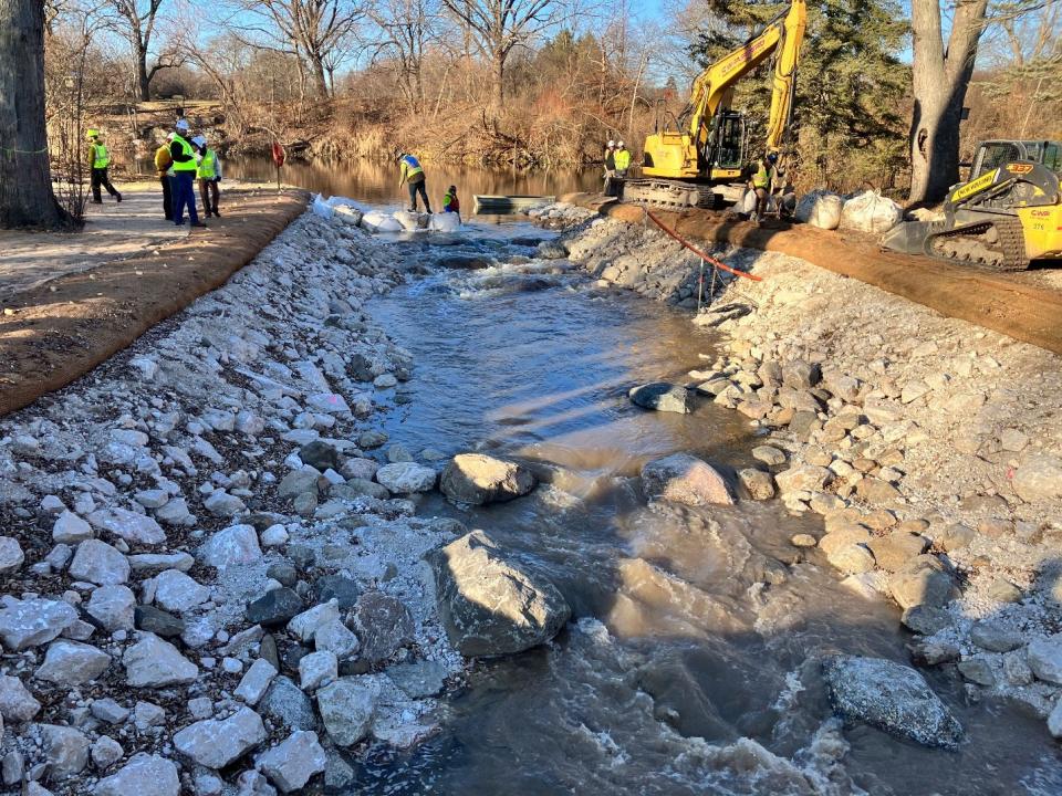 Workers remove a temporary dam put in place to allow for construction of a fish passage around Kletzsch Dam on the Milwaukee River in Glendale.