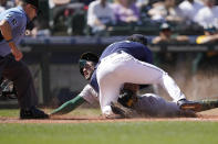 Seattle Mariners pitcher Andres Munoz tags out Oakland Athletics' Luis Barrera at the plate during the seventh inning of a baseball game Wednesday, May 25, 2022, in Seattle. (AP Photo/Ted S. Warren)