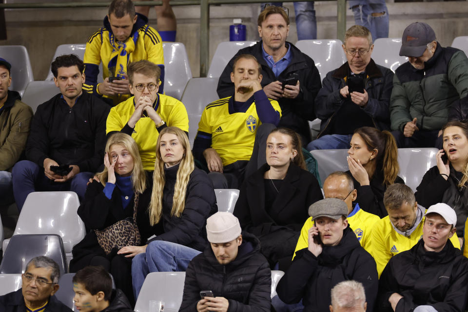 Sweden supporters sit in the stands during the Euro 2024 group F qualifying soccer match between Belgium and Sweden at the King Baudouin Stadium in Brussels, Monday, Oct. 16, 2023. Two Swedes were killed in a shooting late Monday in central Brussels, police said, prompting Belgium's prime minister and senior Cabinet minister to hunker down at their crisis center for an emergency meeting. (AP Photo/Geert Vanden Wijngaert)
