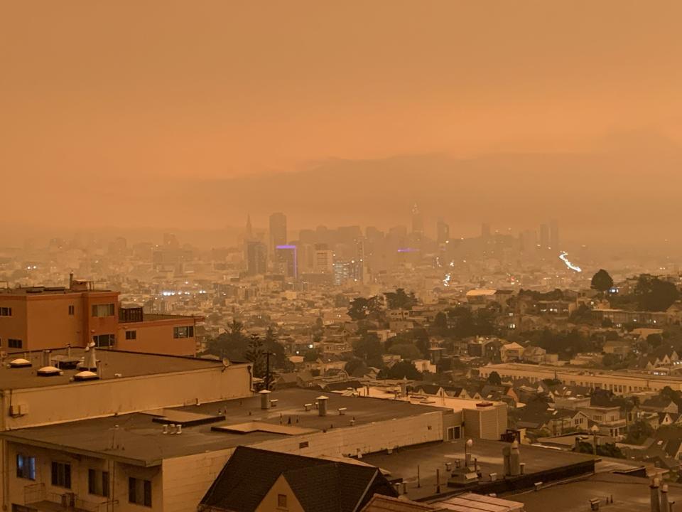 Downtown San Francisco at noon on Wednesday, September 9, 2020 as smoke from multiple wildfires in the region tints the air reddish-orange.