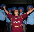 A Maroons fan bravely takes on the Blues in the supporting stakes.
