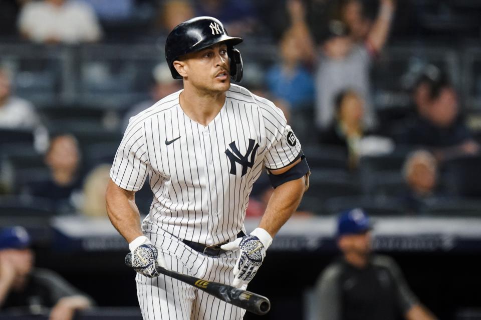 New York Yankees' Giancarlo Stanton watches his sacrifice fly ball that drove in a run during the third inning of a baseball game against the Texas Rangers, Monday, Sept. 20, 2021, in New York. (AP Photo/Frank Franklin II)