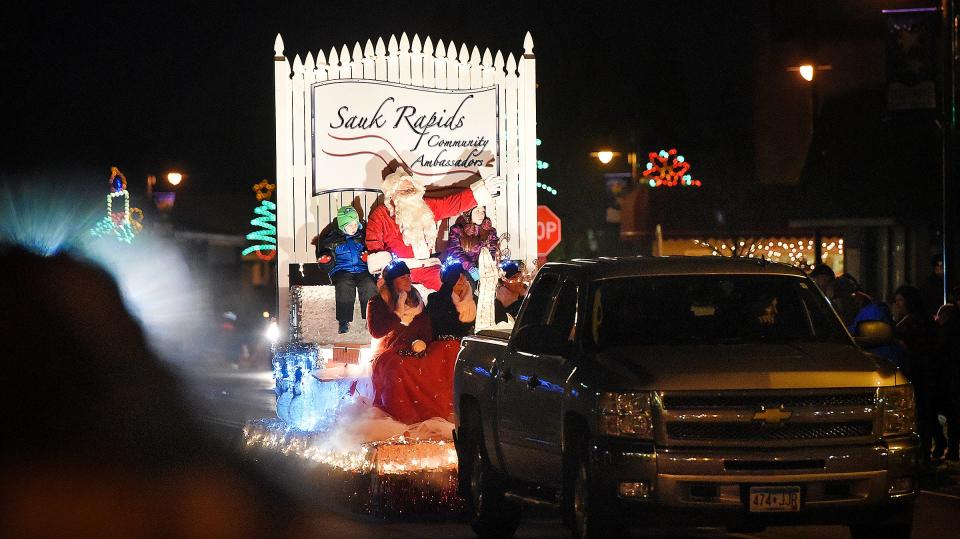 Santa Claus catches a ride on the Sauk Rapids Community Ambassadors float Saturday during the Parade of Lights in downtown Sauk Rapids.