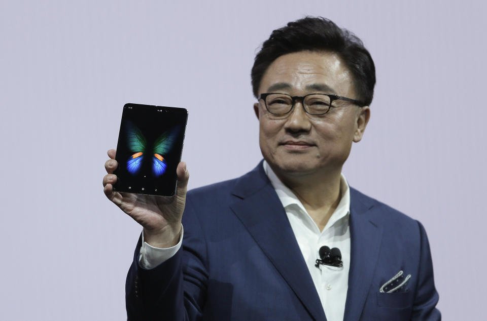 DJ Koh, Samsung President and CEO of IT and Mobile Communications, holds up the new Galaxy Fold smartphone during an event Wednesday, Feb. 20, 2019, in San Francisco. Samsung is hailing the 10th anniversary of its first smartphone with three new models that seem unlikely to reverse a sales slump in an industry recycling the same ideas. (AP Photo/Eric Risberg)