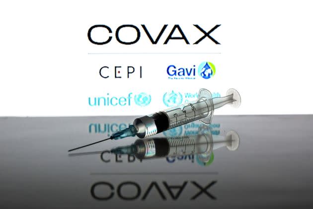 SPAIN - 2021/07/13: In this photo illustration a medical syringe seen displayed in front of the Covax Facility vaccine logo. (Photo Illustration by Thiago Prudencio/SOPA Images/LightRocket via Getty Images) (Photo: SOPA Images via Getty Images)