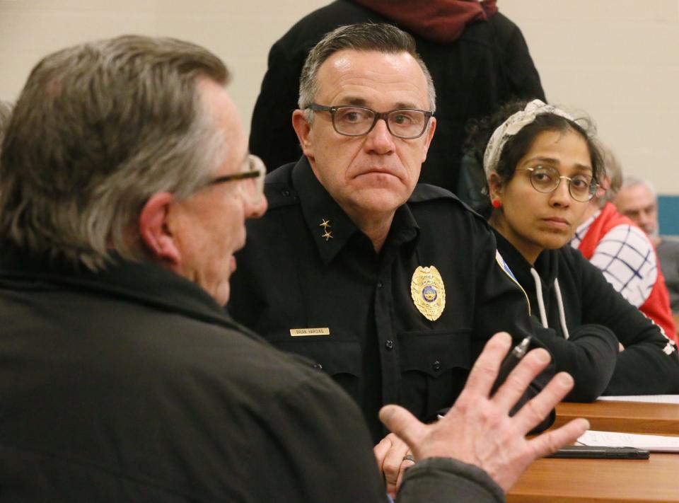 Akron resident Ken Burins asks about American Rescue Plan Act money as Acting Police Chief Brian Harding and resident Parinita Singh listen during a small group breakout session at a City of Akron 2024 Operating Budget Town Hall Wednesday at Firestone High School.