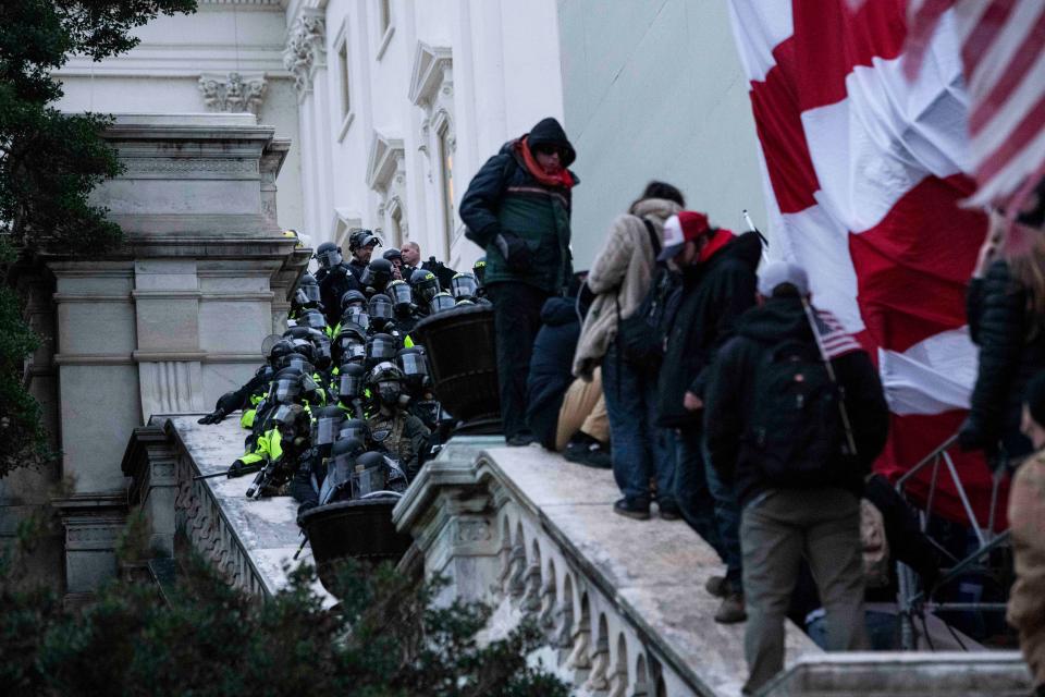 Police tried in vain to keep protesters off the Capitol steps.