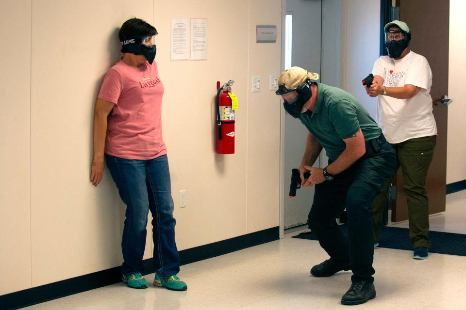 Schoolteachers and administrators participate in an shooter drill  June 28, 2018, during a three-day firearms course at Flatrock Training Center in Commerce City, Colo.