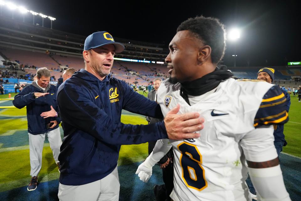 California Golden Bears head coach Justin Wilcox celebrates with defensive back Jeremiah Earby (6) at the end of the game against the UCLA Bruins at Rose Bowl.