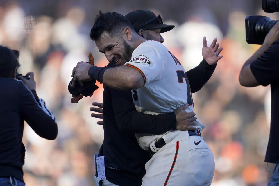 San Francisco Giants' David Villar, foreground, is congratulated by teammates after hitting a two-run single during the 10th inning of a baseball game against the Arizona Diamondbacks in San Francisco, Sunday, Oct. 2, 2022. (AP Photo/Jeff Chiu)