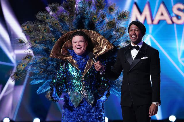 <p>FOX Image Collection via Getty </p> Donny Osmond and host Nick Cannon on 'The Masked Singer'