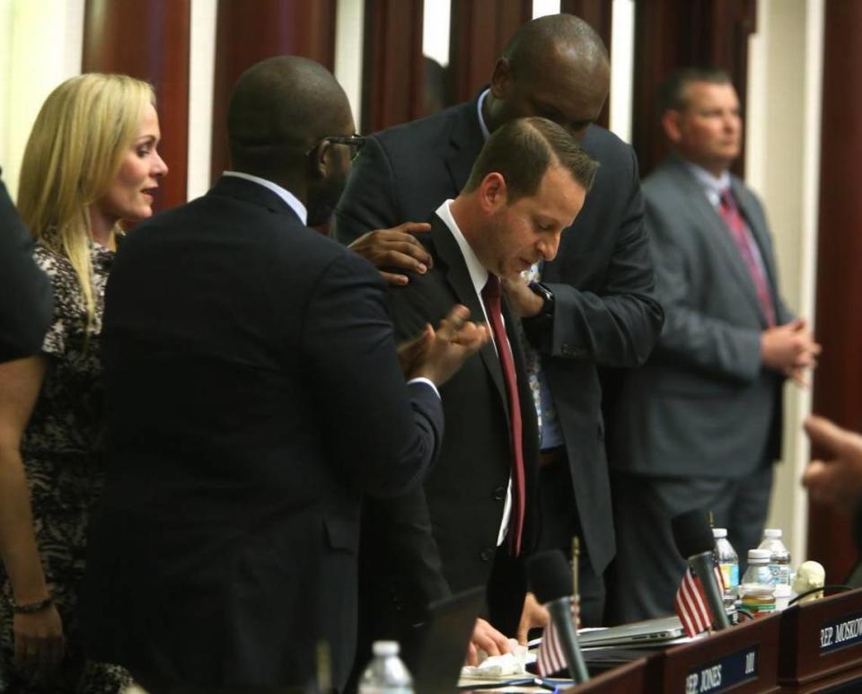 Rep. Jared Moskowitz, D-Coral Springs, center, is consoled by House members and holds back tears after talking about the Marjory Stoneman Douglas High School shooting on the floor of the House.