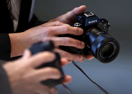 Visitors try out Sony Corp's digital cameras at its headquarters in Tokyo in this February 4, 2015 file photo. REUTERS/Yuya Shino/Files