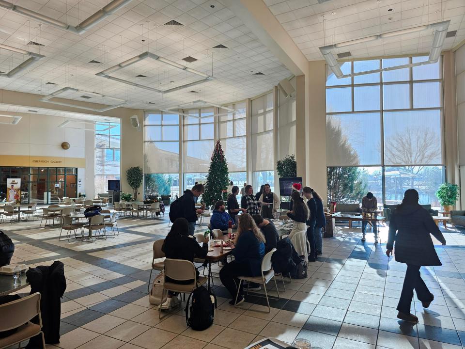 Students gather in the University of Wisconsin Oshkosh- Fond du Lac campus commons area for tree decorating and other activities.