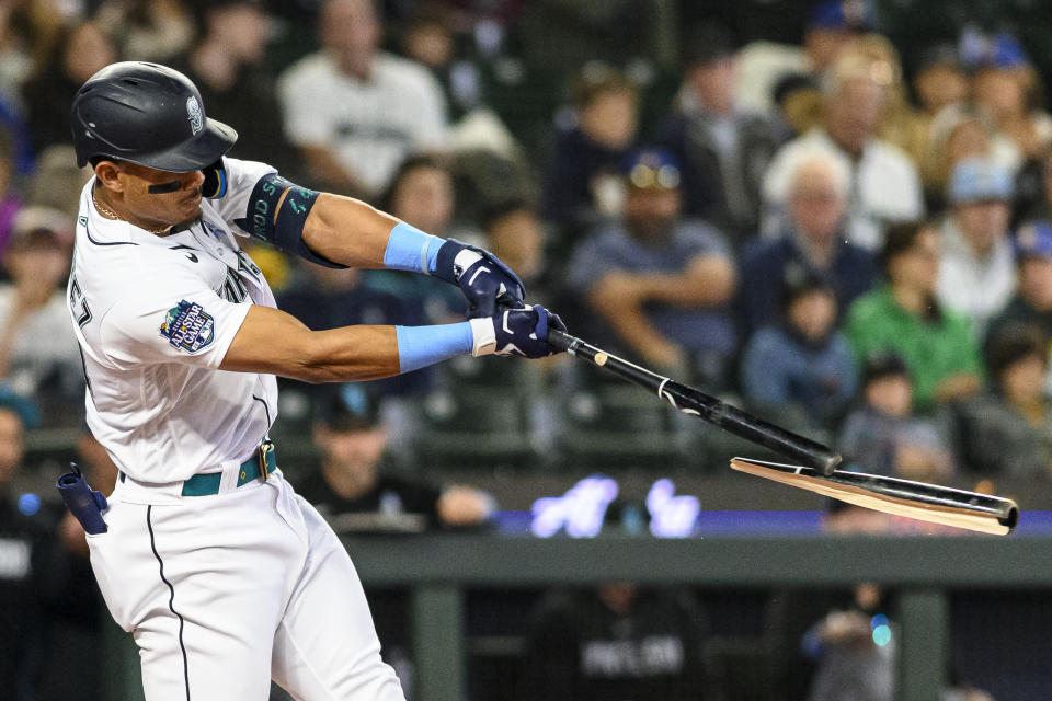 Seattle Mariners' Julio Rodriguez breaks his bat as he flies out against the Chicago White Sox during the first inning of a baseball game, Sunday, June 18, 2023, in Seattle. (AP Photo/Caean Couto)