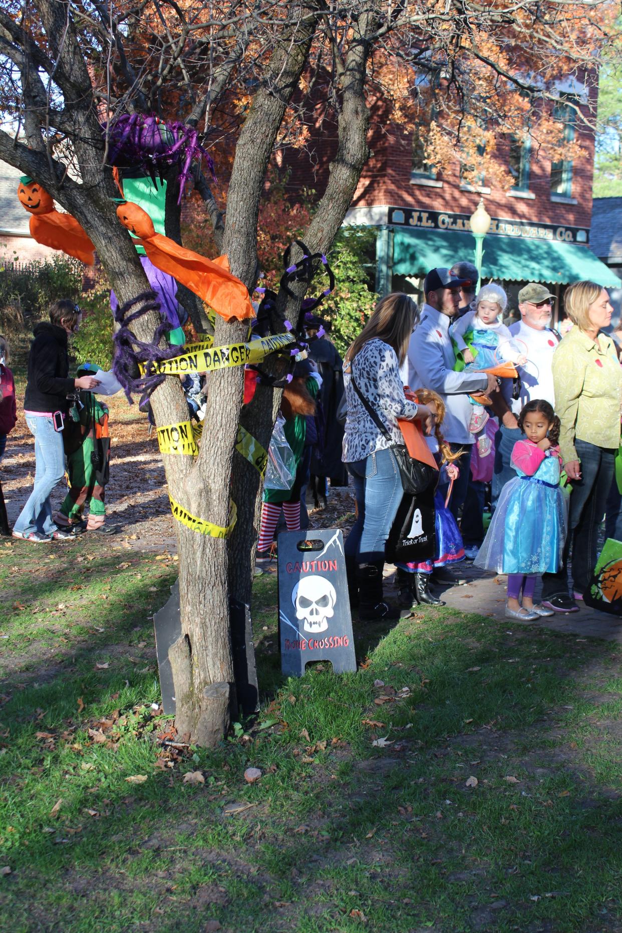 All Hallows Eve visitors wait to get in to one of the trick-or-treat houses Saturday, Oct. 25, 2014, at Midway Village Museum in Rockford.
