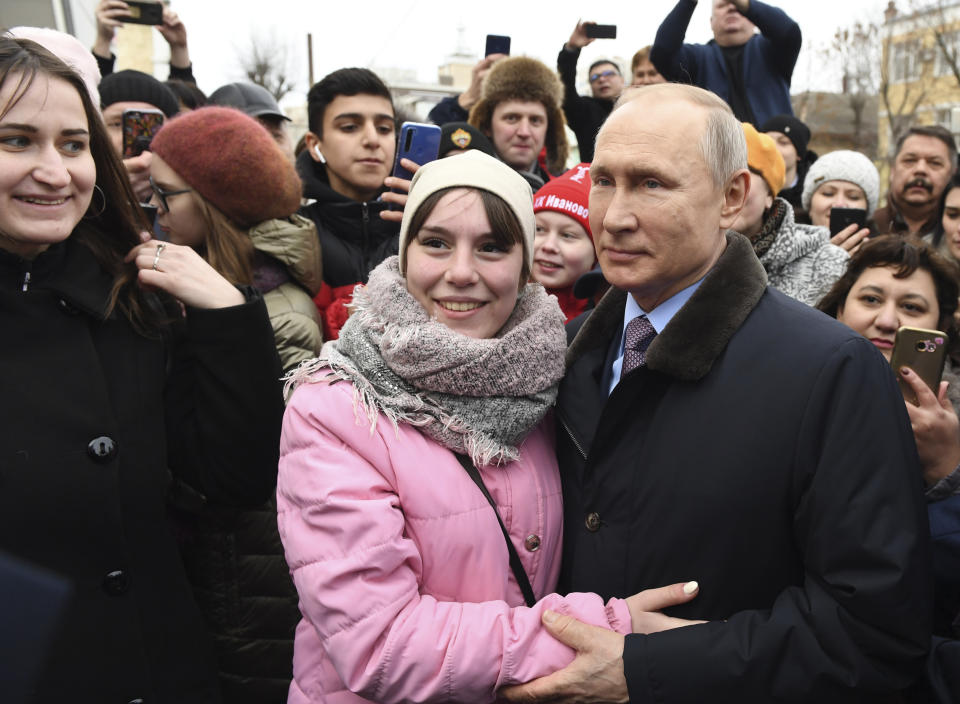 FILE - In this March 6, 2020, file photo, Russian President Vladimir Putin, right, poses for a photo with local citizens in Ivanovo, Russia. Putin is just a step away from bringing about the constitutional changes that would allow him to extend his rule until 2036. The vote that would reset the clock on Putin’s tenure in office and allow him to serve two more six-year terms is set to wrap up Wednesday, July 1, 2020. (Alexei Nikolsky/Sputnik, Kremlin Pool Photo via AP, File)