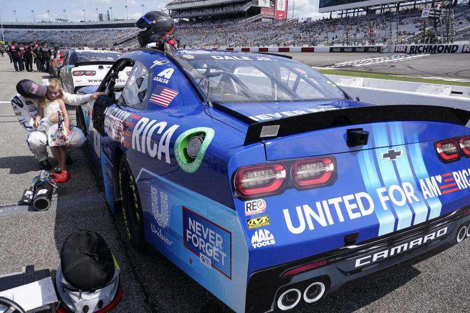 Dale Earnhardt Jr., holds his daughter Isla, 3, during driver introductions prior to the start of the NASCAR Xfinity auto race in Richmond, Va., Saturday, Sept. 11, 2021. (AP Photo/Steve Helber)