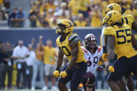 West Virginia linebacker Jared Bartlett (10) reacts after sacking Virginia Tech quarterback Braxton Burmeister (3) during the second half of an NCAA college football game in Morgantown, W.Va., Saturday, Sept. 18, 2021. (AP Photo/William Wotring)