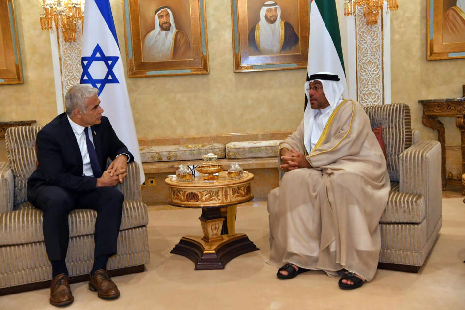 In this photo made available by the Israeli Government Press Office, In this photo made available by the Israeli Government Press Office, United Arab Emirates Minister of State Ahmed Ali Al Sayegh, right, and Israeli Foreign Minister Yair Lapid, speak during a meeting in Abu Dhabi, United Arab Emirates, Tuesday, June 29, 2021. Israel’s new foreign minister is in the UAE on the first high-level trip by an Israeli official to the Gulf Arab state since the two countries normalized relations last year. (Shlomi Amsalem/Government Press Office via AP)