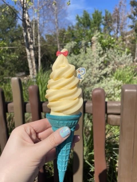 snow white ice cream cone in a hand at magic kingdom