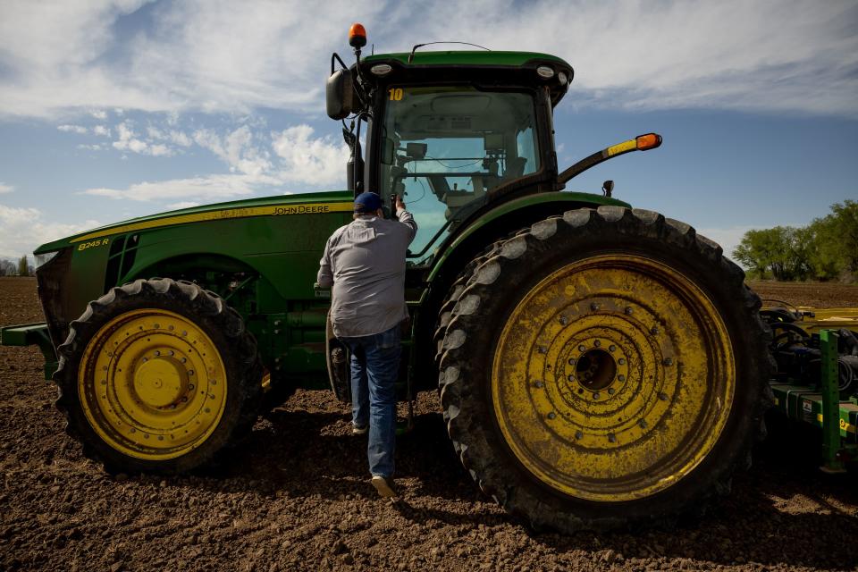 Ron Gibson, owner of Gibson’s Green Acres and president of the Utah Farm Bureau, hops in his tractor while planting corn in Ogden on Thursday, May 4, 2023. | Spenser Heaps, Deseret News