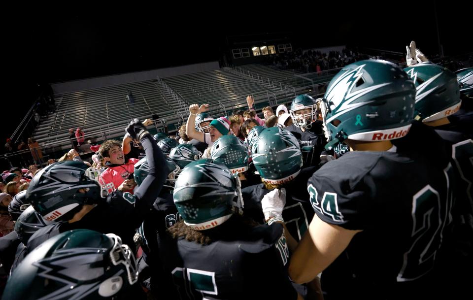 Williamston players celebrate with fans after defeating Olivet, Friday, Oct. 14, 2022, in Williamston. Williamston won 29-22.