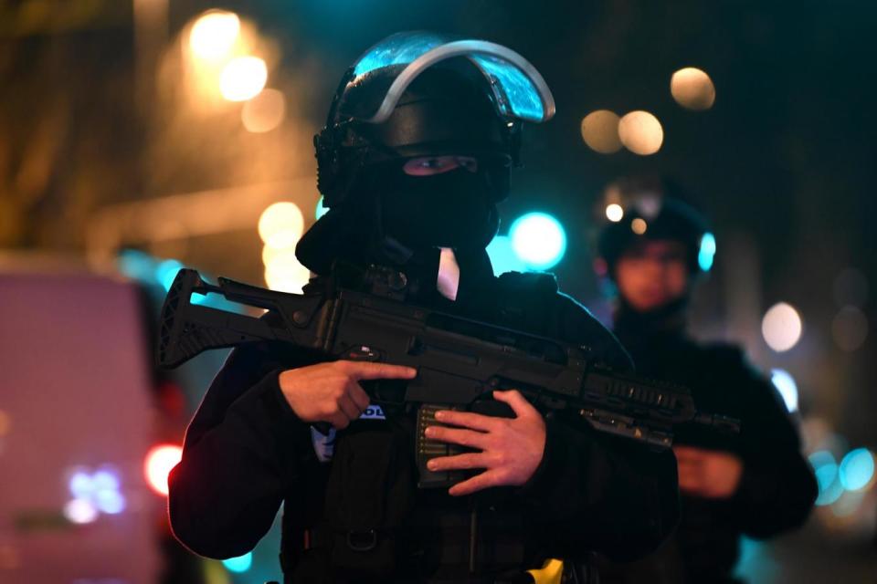 Armed police stand guard near the scene of the attack on Tuesday night (EPA)