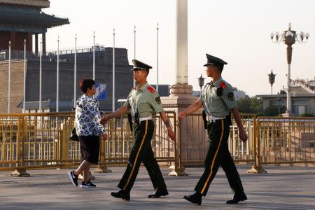 Paramilitary policemen patrol the area around Tiananmen Square in Beijing, China June 4, 2017. REUTERS/Thomas Peter