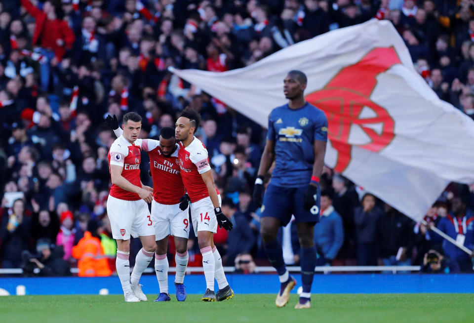 Soccer Football - Premier League - Arsenal v Manchester United - Emirates Stadium, London, Britain - March 10, 2019  Arsenal's Granit Xhaka celebrates scoring their first goal with Alexandre Lacazette and Pierre-Emerick Aubameyang as Manchester United's Paul Pogba looks dejected   REUTERS/Eddie Keogh  EDITORIAL USE ONLY. No use with unauthorized audio, video, data, fixture lists, club/league logos or "live" services. Online in-match use limited to 75 images, no video emulation. No use in betting, games or single club/league/player publications.  Please contact your account representative for further details.