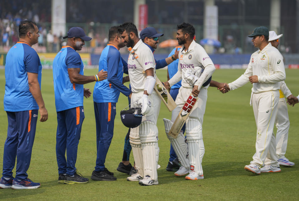 India's Cheteshwar Pujara, center left and Srikar Bharat, center right greet others as they return to the dressing room after winning the second cricket test match between India and Australia in New Delhi, India, Sunday, Feb. 19, 2023. (AP Photo/Altaf Qadri)