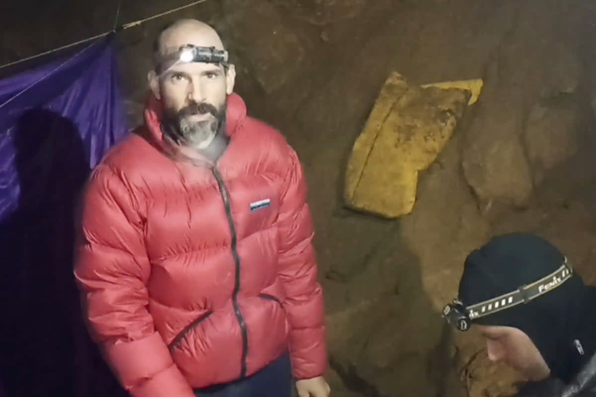 In this screen grab from video, American caver Mark Dickey, 40, talks to camera next to a colleague inside the Morca cave near Anamur, southern Turkey (AP)