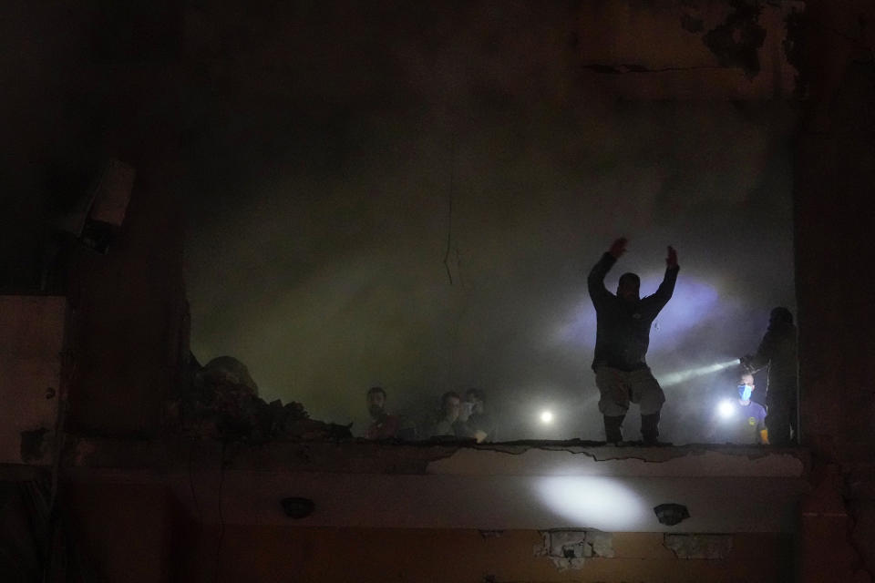 People search for survivors inside an apartment following a massive explosion in the southern Beirut, Lebanon, Tuesday, Jan. 2, 2024. The TV station of Lebanon's Hezbollah group says top Hamas official Saleh Arouri was killed Tuesday in an explosion in a southern Beirut suburb. (AP Photo/Bilal Hussein)