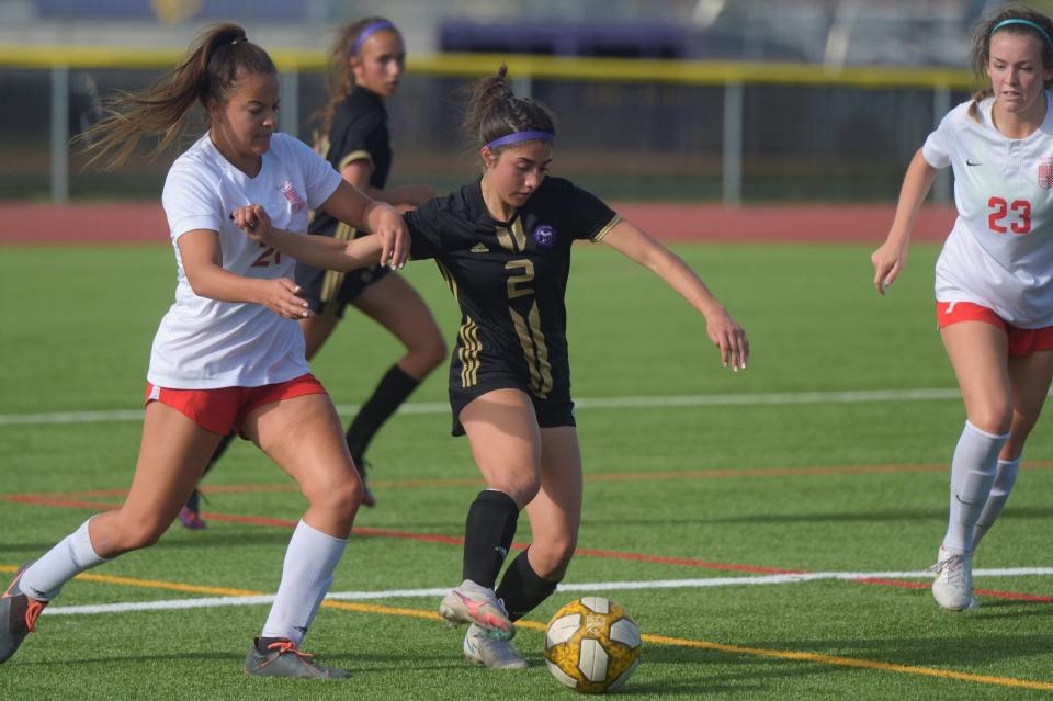 Fort Collins girls soccer player Maria Armatas fights off defenders during a Class 5A first-round playoff game on Tuesday, May 10, 2022, in Fort Collins, Colo. No. 16 Fort Collins lost 2-1 in overtime to No. 17 Regis Jesuit.